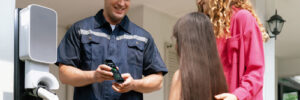 FAQ service man explaining system to woman and daughter