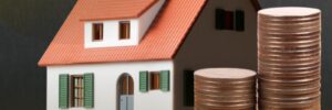 Graphic containing stacks of coins surrounded by bright assets and a house in the background